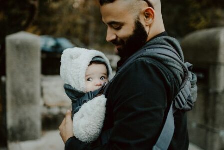 Dad holding baby in a carrier